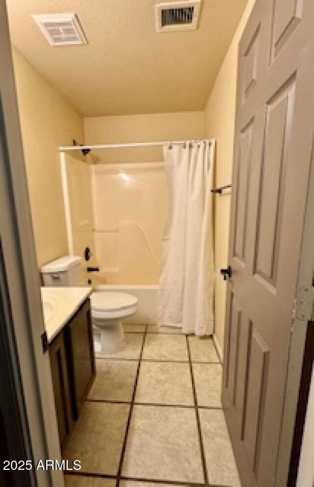 full bathroom with toilet, vanity, visible vents, and tile patterned floors