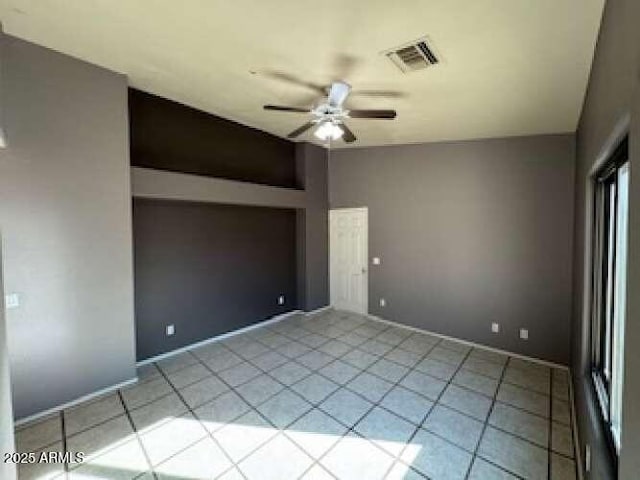 spare room featuring visible vents, ceiling fan, and light tile patterned floors