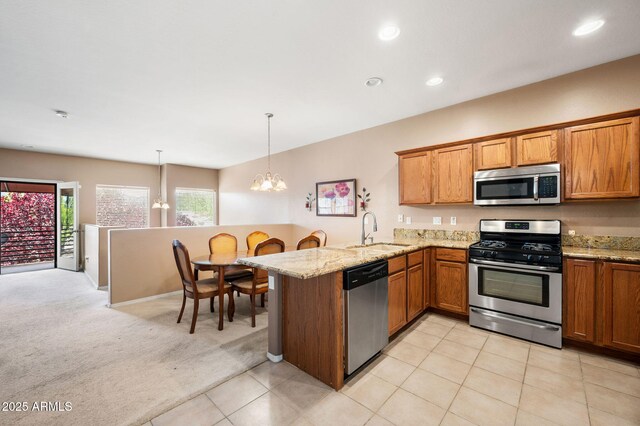 997 Fairway Dr, Dewey, AZ 86327 - kitchen with an inviting chandelier, a sink, brown cabinets, and stainless steel appliances