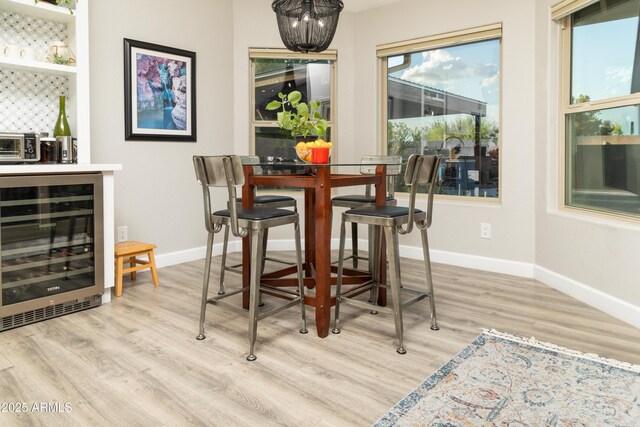 136 E Vera Ln, Tempe, AZ 85284 - dining space featuring wine cooler, wood finished floors, a dry bar, and a chandelier