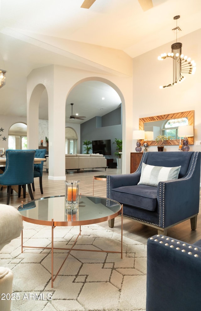 136 E Vera Ln, Tempe, AZ 85284 - living area featuring arched walkways, vaulted ceiling, wood finished floors, and a chandelier