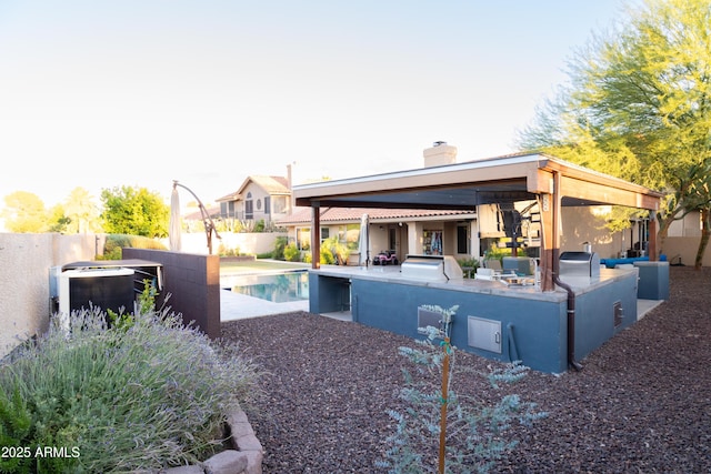 136 E Vera Ln, Tempe, AZ 85284 - rear view of property featuring exterior kitchen, a chimney, an outdoor pool, and a patio area