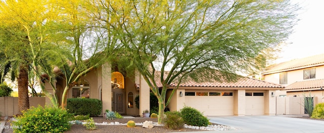 136 E Vera Ln, Tempe, AZ 85284 - mediterranean / spanish house featuring stucco siding, concrete driveway, a garage, and a tiled roof