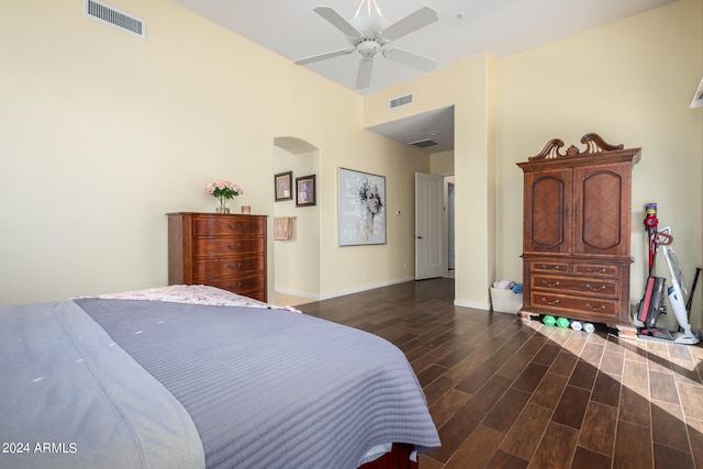 bedroom with dark hardwood / wood-style flooring and ceiling fan