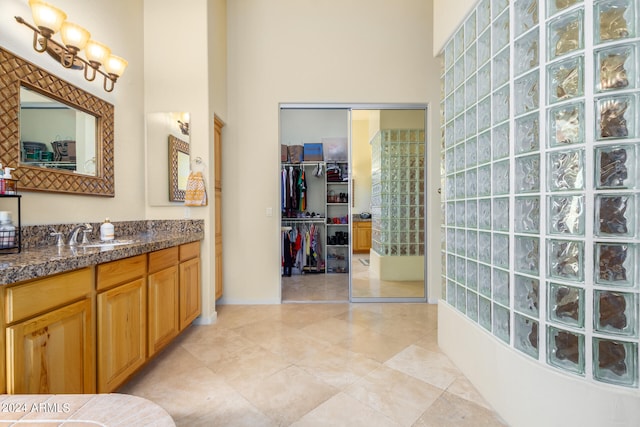 bathroom featuring vanity and a high ceiling