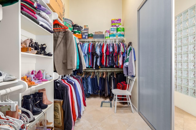 walk in closet with light tile patterned flooring