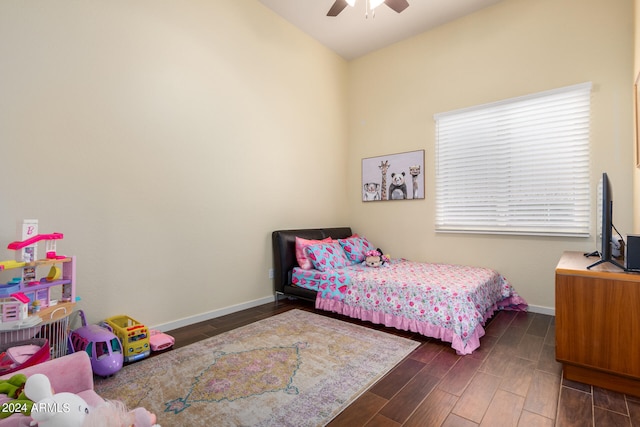 bedroom with dark hardwood / wood-style flooring and ceiling fan