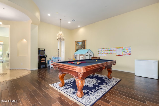 playroom featuring dark hardwood / wood-style floors, an inviting chandelier, and pool table