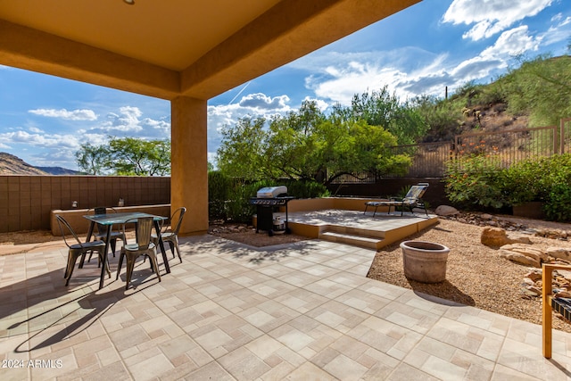 view of patio featuring a grill