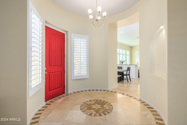 foyer entrance featuring a notable chandelier and light tile patterned flooring