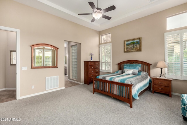 carpeted bedroom featuring connected bathroom and ceiling fan