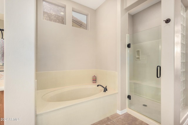 bathroom featuring tile patterned flooring and independent shower and bath