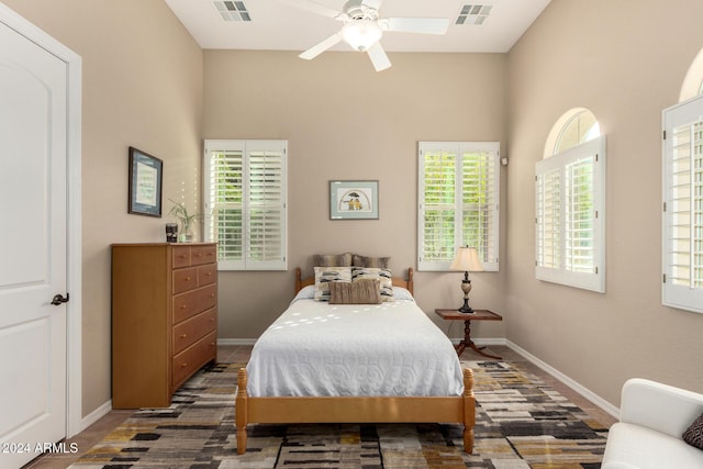 bedroom featuring multiple windows and ceiling fan