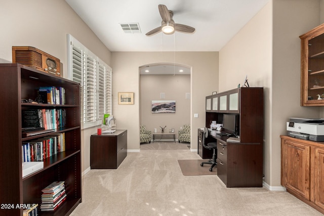 carpeted office space with ceiling fan