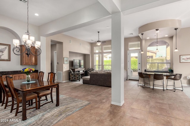 dining room featuring ceiling fan with notable chandelier