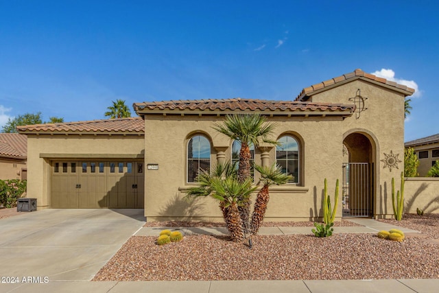 mediterranean / spanish-style house featuring a garage