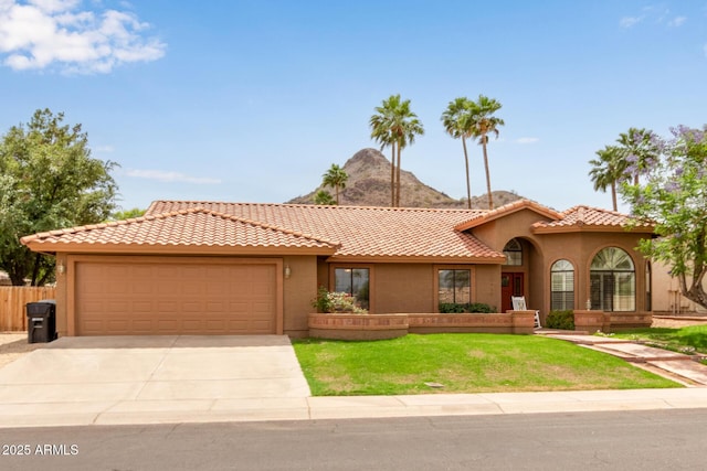 15430 N 19th Way, Phoenix, AZ 85022 - mediterranean / spanish home with a garage, driveway, stucco siding, and a front lawn