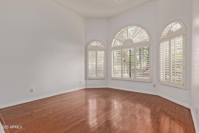 15430 N 19th Way, Phoenix, AZ 85022 - spare room featuring plenty of natural light, hardwood / wood-style flooring, and baseboards