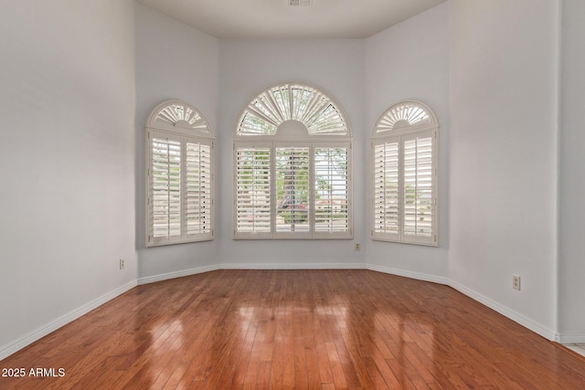 15430 N 19th Way, Phoenix, AZ 85022 - spare room featuring plenty of natural light, hardwood / wood-style floors, and baseboards
