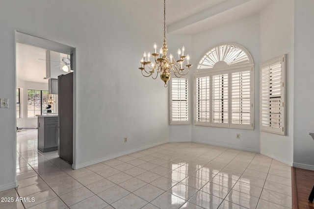 15430 N 19th Way, Phoenix, AZ 85022 - spare room featuring light tile patterned floors, a chandelier, baseboards, and a towering ceiling