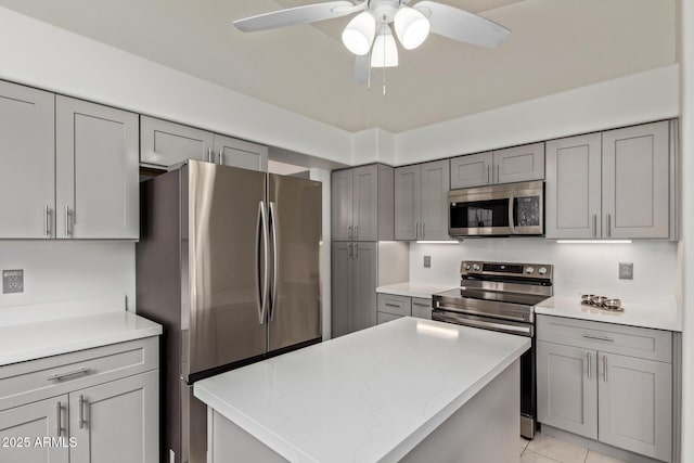 15430 N 19th Way, Phoenix, AZ 85022 - kitchen with appliances with stainless steel finishes, gray cabinetry, a ceiling fan, a kitchen island, and light tile patterned floors