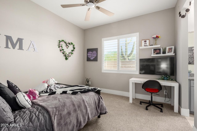 bedroom with a ceiling fan, light carpet, and baseboards