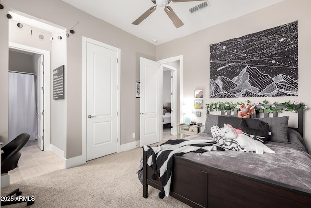 bedroom featuring light carpet, baseboards, visible vents, and a ceiling fan