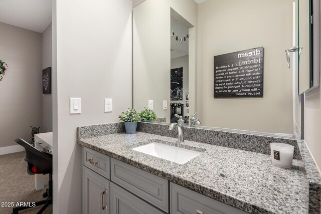 bathroom featuring baseboards and vanity