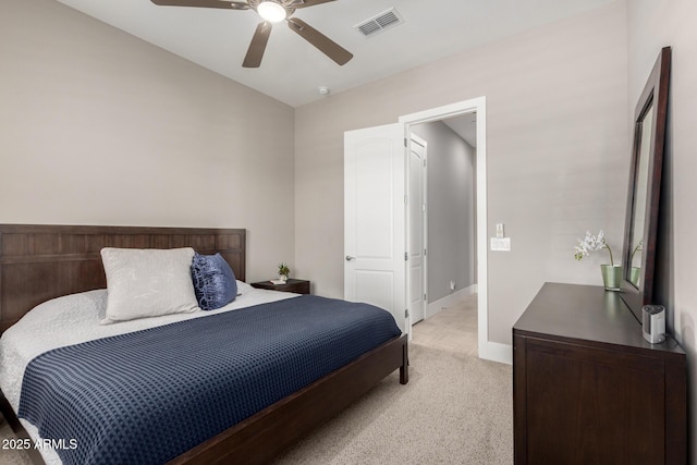 bedroom with light colored carpet, visible vents, baseboards, and a ceiling fan