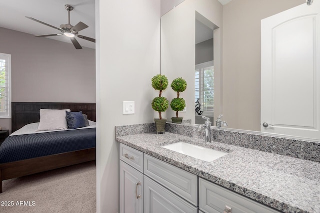bathroom featuring a ceiling fan, vanity, and a healthy amount of sunlight