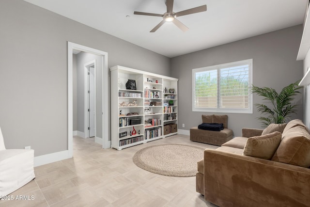 sitting room featuring baseboards and a ceiling fan