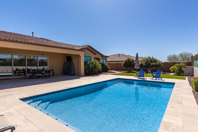 view of swimming pool with a fenced backyard, ceiling fan, a patio area, and a fenced in pool