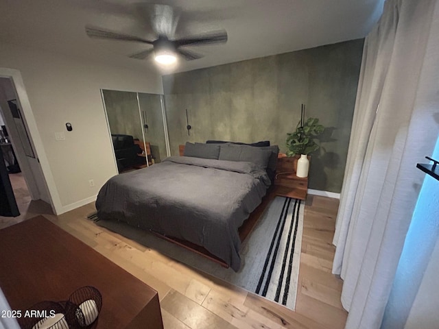 7802 E Hubbell St, Scottsdale, AZ 85257 - bedroom with wood finished floors, a closet, a ceiling fan, and baseboards