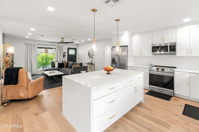 7802 E Hubbell St, Scottsdale, AZ 85257 - kitchen featuring appliances with stainless steel finishes, recessed lighting, light wood-style floors, light countertops, and backsplash
