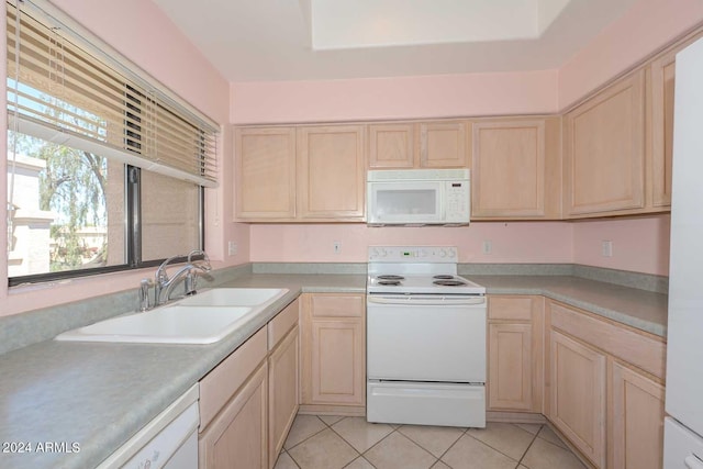 kitchen featuring light brown cabinetry, sink, white appliances, and light tile floors