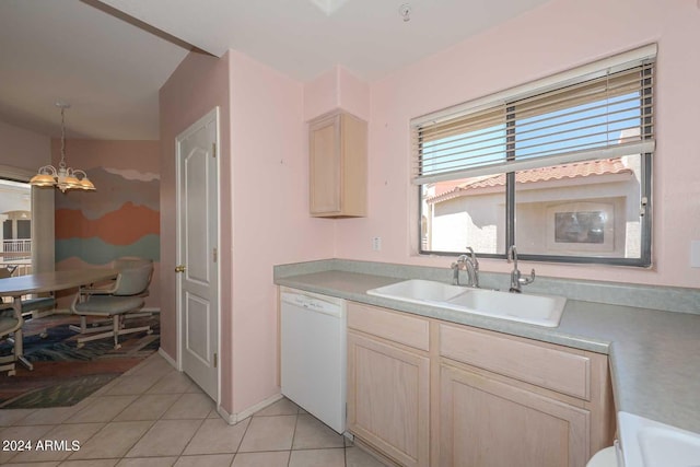 kitchen with decorative light fixtures, light brown cabinetry, light tile floors, sink, and dishwasher