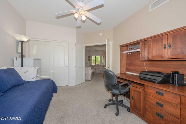 carpeted office space with ceiling fan