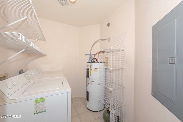 laundry area with light tile floors, washer hookup, washer and clothes dryer, and electric water heater