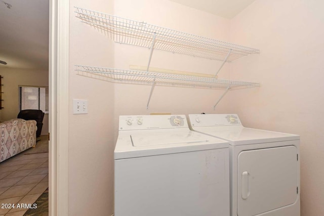 laundry area featuring washing machine and dryer and tile floors