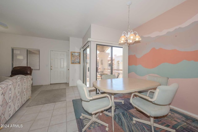 dining area featuring light tile floors and a chandelier