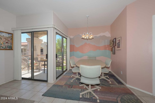 dining room featuring light tile floors and a chandelier