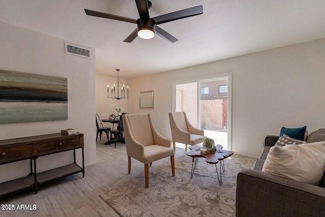 4268 N 68th Ave, Phoenix, AZ 85033 - living area with a chandelier, a ceiling fan, and light wood finished floors