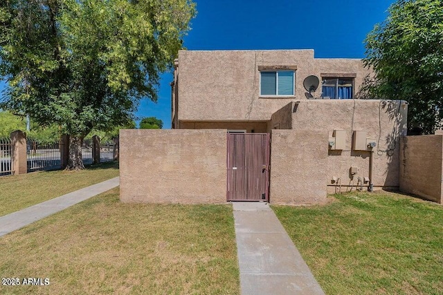 4268 N 68th Ave, Phoenix, AZ 85033 - view of front facade featuring stucco siding and a gate
