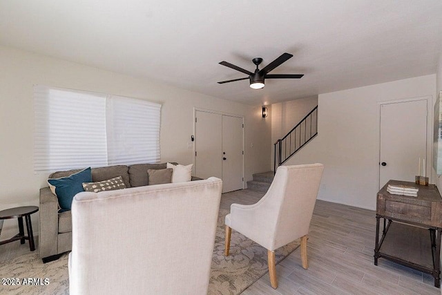 4268 N 68th Ave, Phoenix, AZ 85033 - living area with ceiling fan, stairs, and light wood finished floors