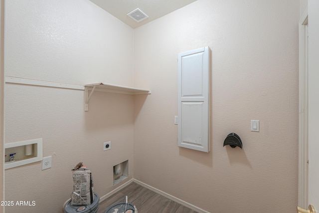 clothes washing area featuring laundry area, visible vents, wood finished floors, washer hookup, and electric dryer hookup