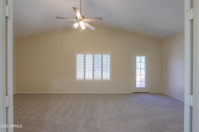 empty room featuring light carpet, ceiling fan, baseboards, and lofted ceiling