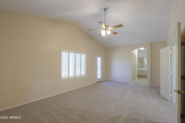 unfurnished room with a ceiling fan, arched walkways, light carpet, and lofted ceiling