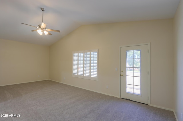 unfurnished room with lofted ceiling, ceiling fan, light carpet, and a healthy amount of sunlight