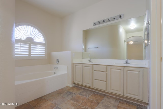 full bath with double vanity, a garden tub, and a sink