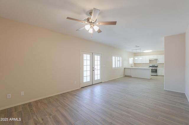 unfurnished living room featuring ceiling fan, french doors, light wood-style flooring, and baseboards